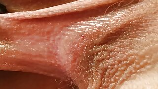 Pulling and stretching her labia